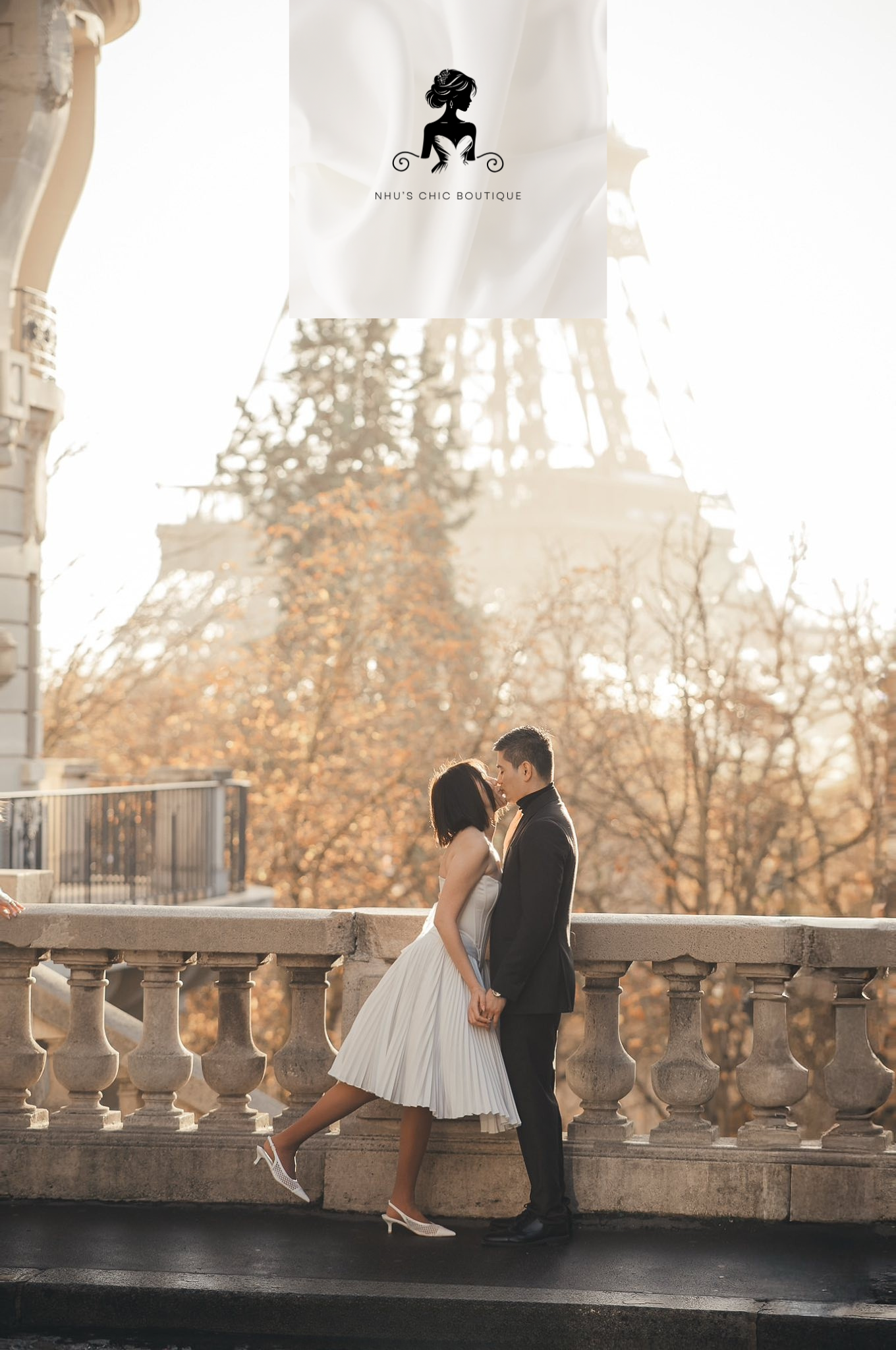 A romantic shot of a couple kissing in Paris, with the bride wearing the Genevieve strapless corset gown.