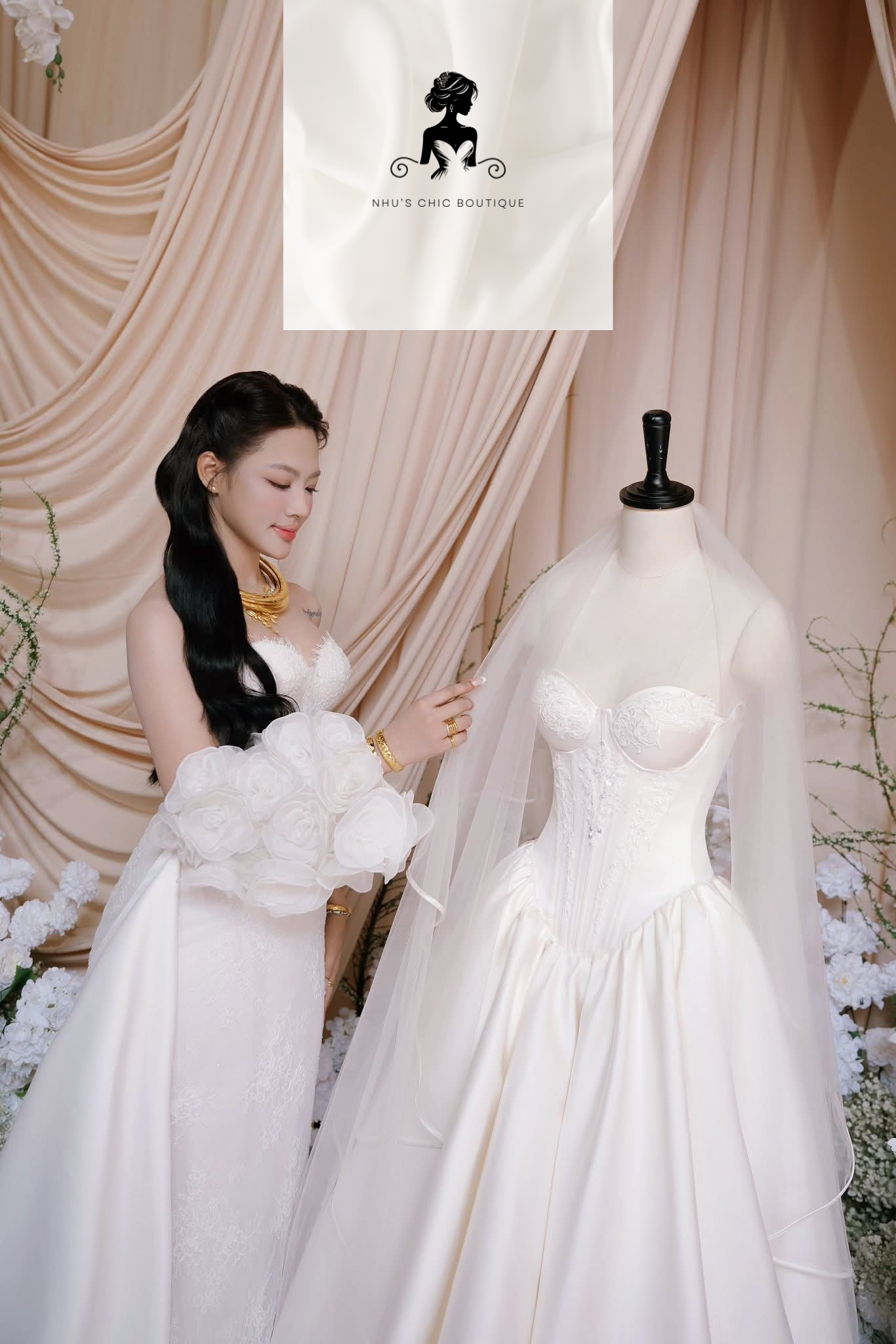 A bride standing next to a bridal mannequin, showcasing two different gown styles. The bride wears a textured corset dress with detachable 3D floral sleeves, while the mannequin displays a classic ballgown with a sweetheart neckline and a delicate tulle veil.