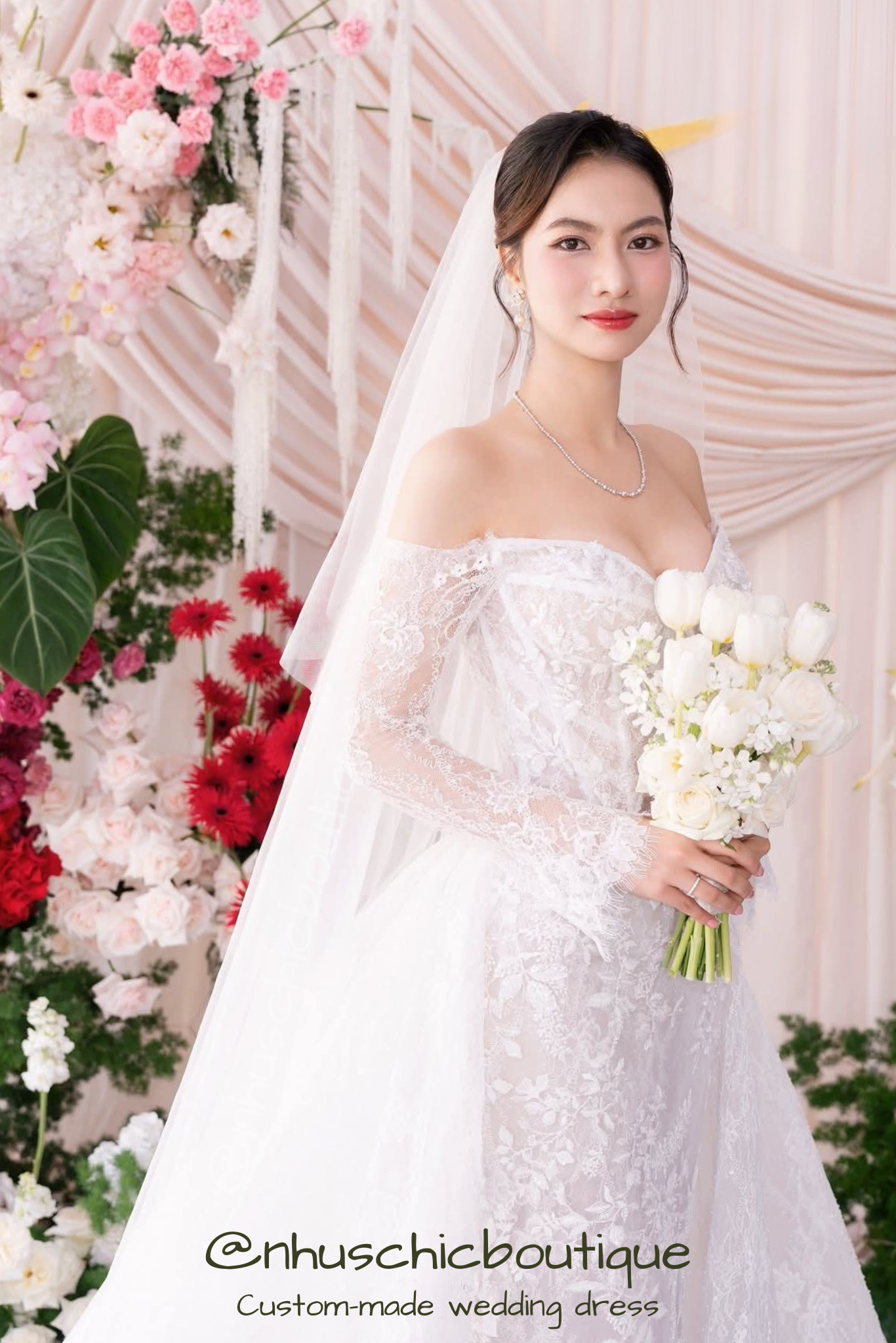 Japanese bride in "Yume-Hana" off-shoulder lace wedding dress holding white tulips.