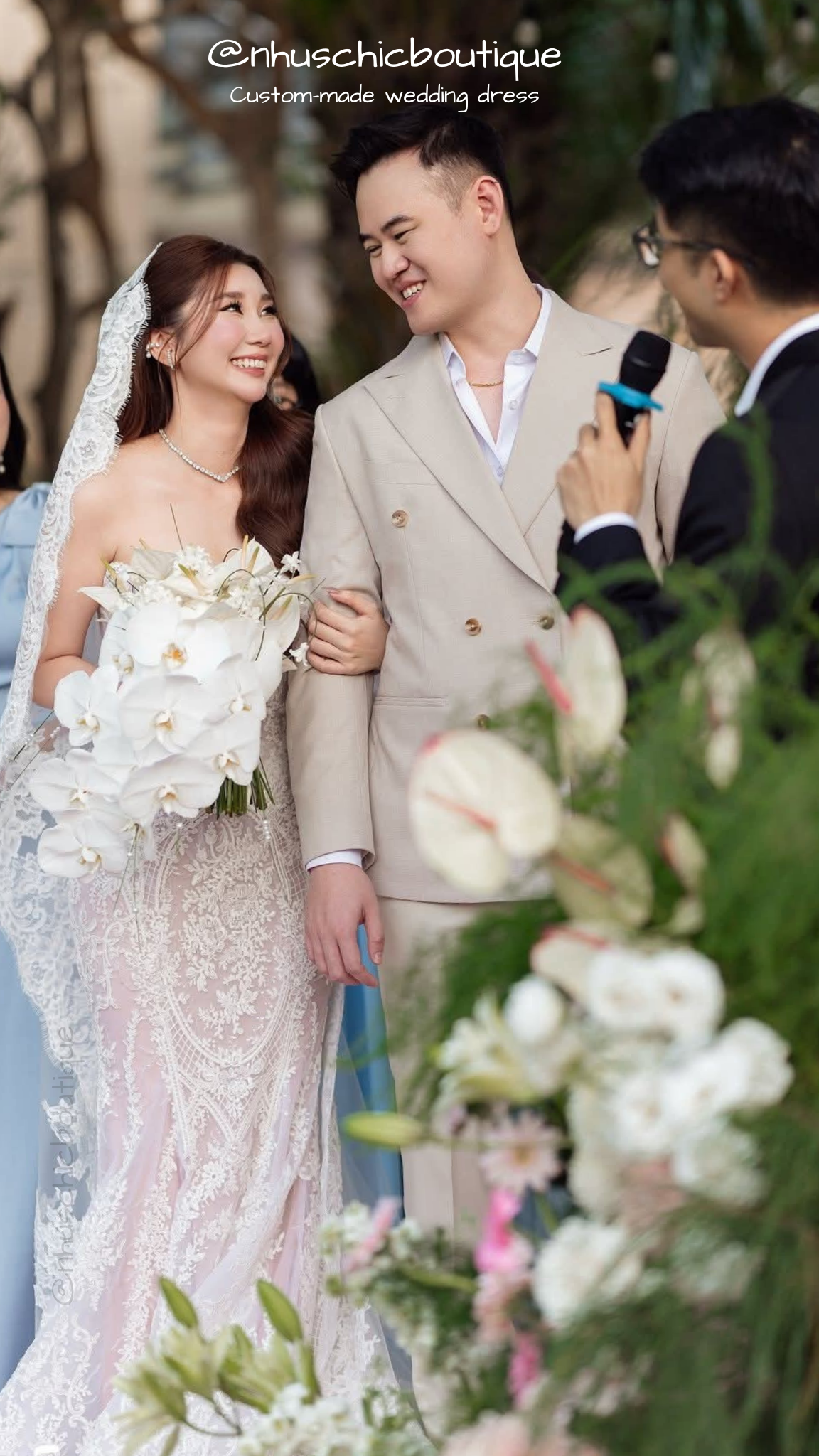 Close-up of the "Isla" gown's intricate lace pattern and strapless sweetheart neckline during a wedding ceremony.