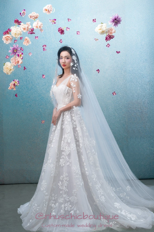 Full-length view of the A-line "Hana-Gasumi" gown with a sweeping cathedral-length floral veil.
